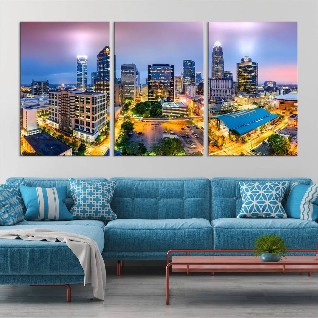 The "Charlotte City Lights Sunset Purple Skyline Cityscape View Wall Art Canvas Print" features a triptych of a vibrant city skyline at dusk, highlighting illuminated skyscrapers and urban streets. This artwork is crafted on museum-quality polycotton canvas, with its gallery-wrapped design ensuring durability and visual appeal for years to come.