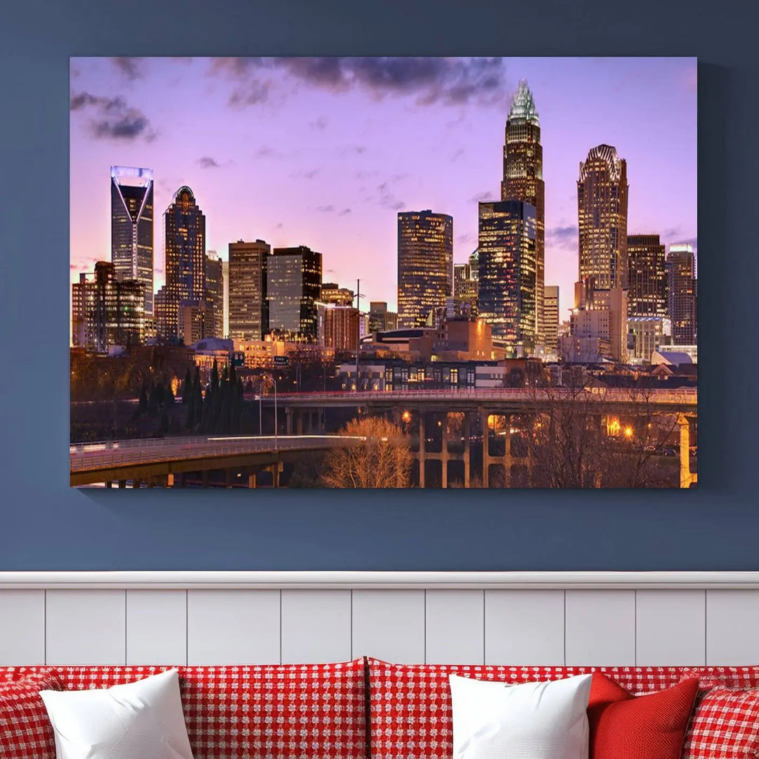 The "Charlotte City Lights Sunset Purple Skyline Cityscape View Wall Art Canvas Print" adorns the modern living room. This museum-quality piece is ready to hang and features a UV-protective coating to preserve its vibrant colors for years.