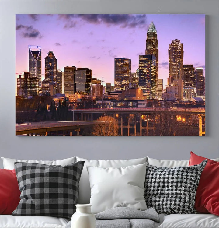 The "Charlotte City Lights Sunset Purple Skyline Cityscape View Wall Art Canvas Print" adorns the modern living room. This museum-quality piece is ready to hang and features a UV-protective coating to preserve its vibrant colors for years.