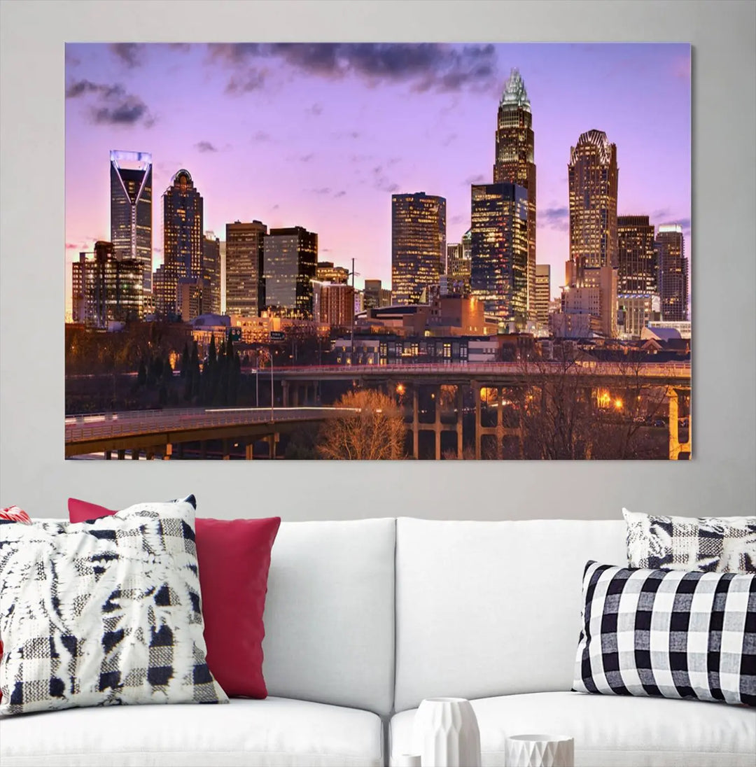 The "Charlotte City Lights Sunset Purple Skyline Cityscape View Wall Art Canvas Print" adorns the modern living room. This museum-quality piece is ready to hang and features a UV-protective coating to preserve its vibrant colors for years.