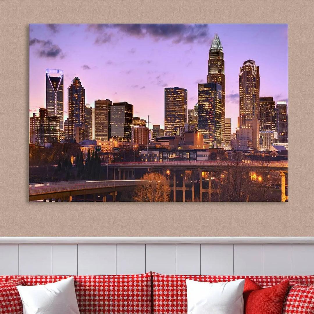 The "Charlotte City Lights Sunset Purple Skyline Cityscape View Wall Art Canvas Print" adorns the modern living room. This museum-quality piece is ready to hang and features a UV-protective coating to preserve its vibrant colors for years.