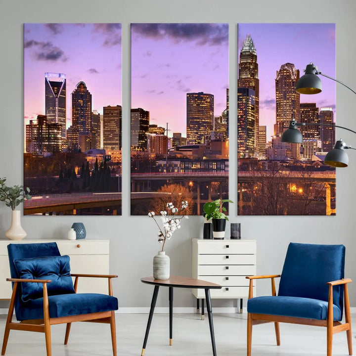 The "Charlotte City Lights Sunset Purple Skyline Cityscape View Wall Art Canvas Print" adorns the modern living room. This museum-quality piece is ready to hang and features a UV-protective coating to preserve its vibrant colors for years.