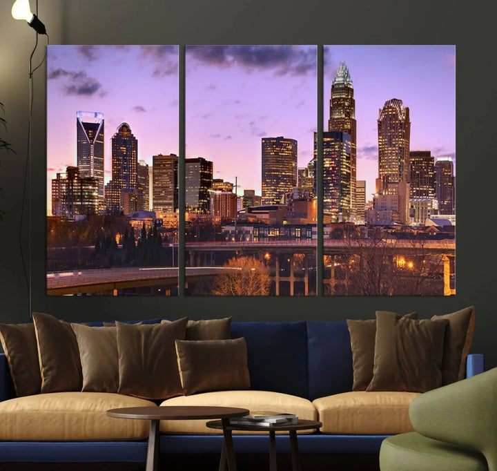 The "Charlotte City Lights Sunset Purple Skyline Cityscape View Wall Art Canvas Print" adorns the modern living room. This museum-quality piece is ready to hang and features a UV-protective coating to preserve its vibrant colors for years.