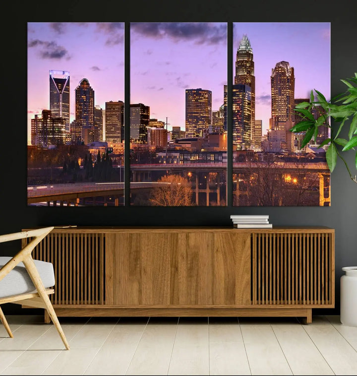 The "Charlotte City Lights Sunset Purple Skyline Cityscape View Wall Art Canvas Print" adorns the modern living room. This museum-quality piece is ready to hang and features a UV-protective coating to preserve its vibrant colors for years.