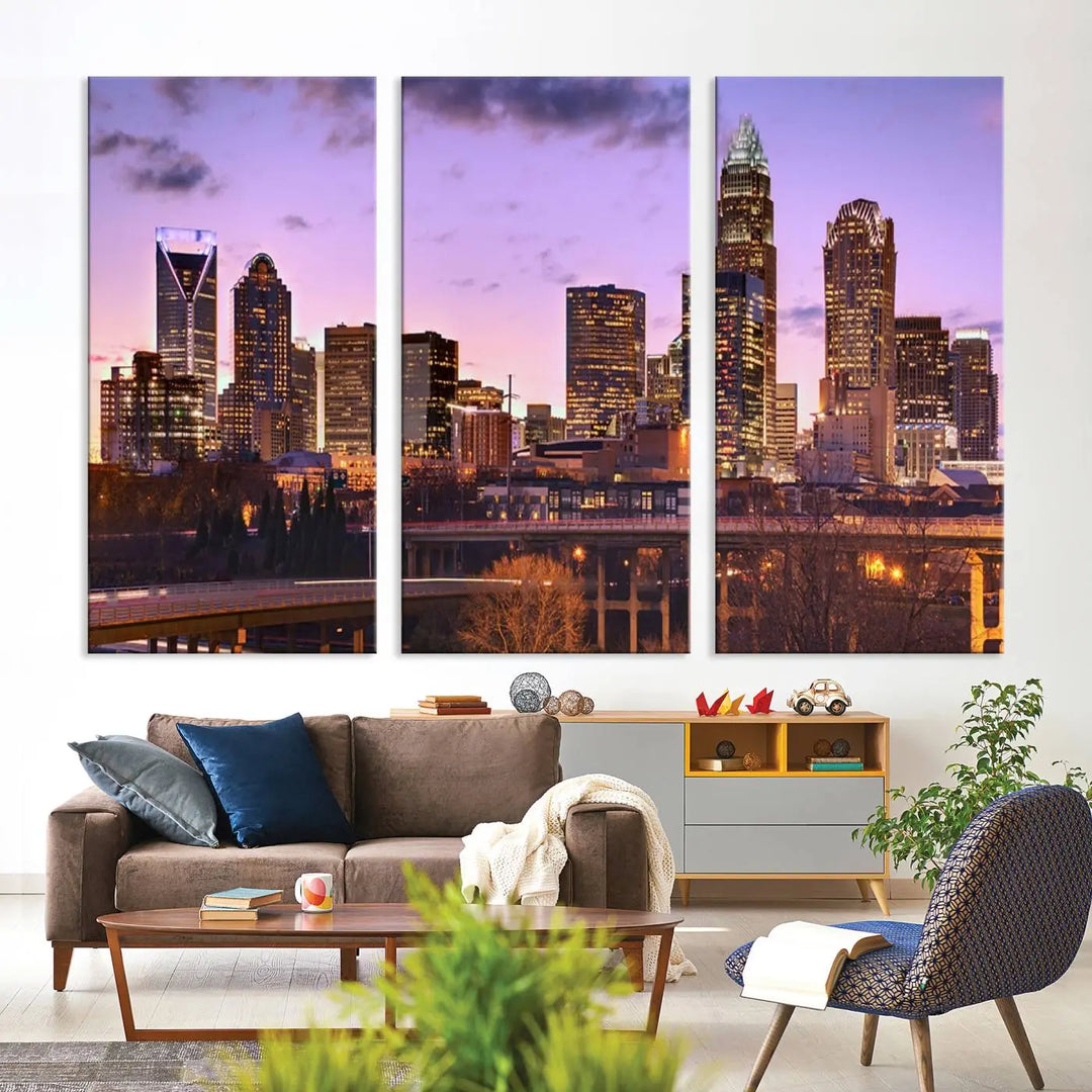 The "Charlotte City Lights Sunset Purple Skyline Cityscape View Wall Art Canvas Print" adorns the modern living room. This museum-quality piece is ready to hang and features a UV-protective coating to preserve its vibrant colors for years.