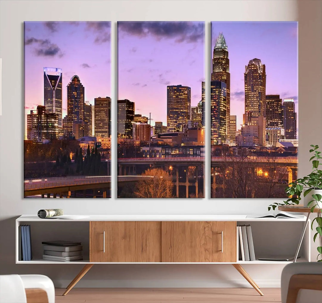 The "Charlotte City Lights Sunset Purple Skyline Cityscape View Wall Art Canvas Print" adorns the modern living room. This museum-quality piece is ready to hang and features a UV-protective coating to preserve its vibrant colors for years.