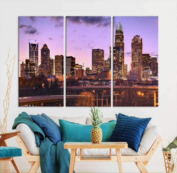 The "Charlotte City Lights Sunset Purple Skyline Cityscape View Wall Art Canvas Print" adorns the modern living room. This museum-quality piece is ready to hang and features a UV-protective coating to preserve its vibrant colors for years.