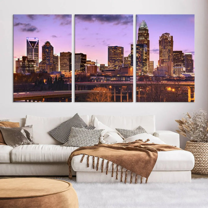 The "Charlotte City Lights Sunset Purple Skyline Cityscape View Wall Art Canvas Print" adorns the modern living room. This museum-quality piece is ready to hang and features a UV-protective coating to preserve its vibrant colors for years.