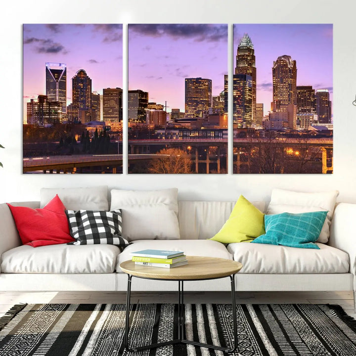 The "Charlotte City Lights Sunset Purple Skyline Cityscape View Wall Art Canvas Print" adorns the modern living room. This museum-quality piece is ready to hang and features a UV-protective coating to preserve its vibrant colors for years.