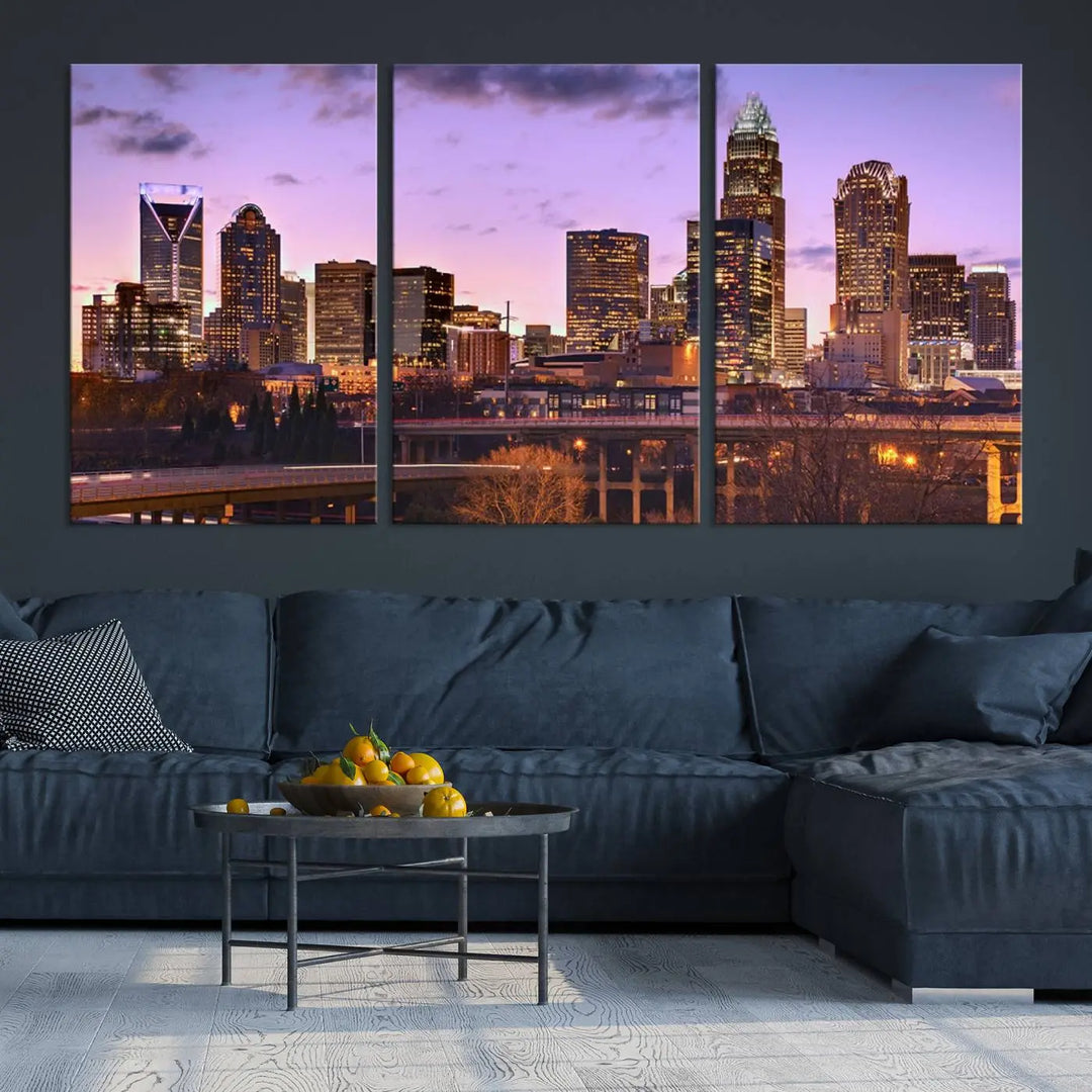 The "Charlotte City Lights Sunset Purple Skyline Cityscape View Wall Art Canvas Print" adorns the modern living room. This museum-quality piece is ready to hang and features a UV-protective coating to preserve its vibrant colors for years.