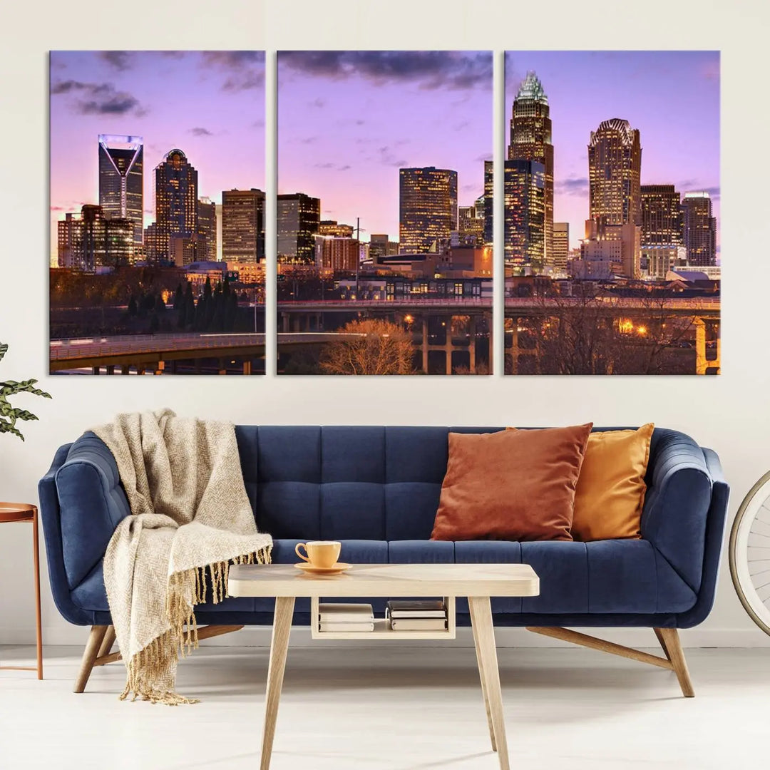 The "Charlotte City Lights Sunset Purple Skyline Cityscape View Wall Art Canvas Print" adorns the modern living room. This museum-quality piece is ready to hang and features a UV-protective coating to preserve its vibrant colors for years.