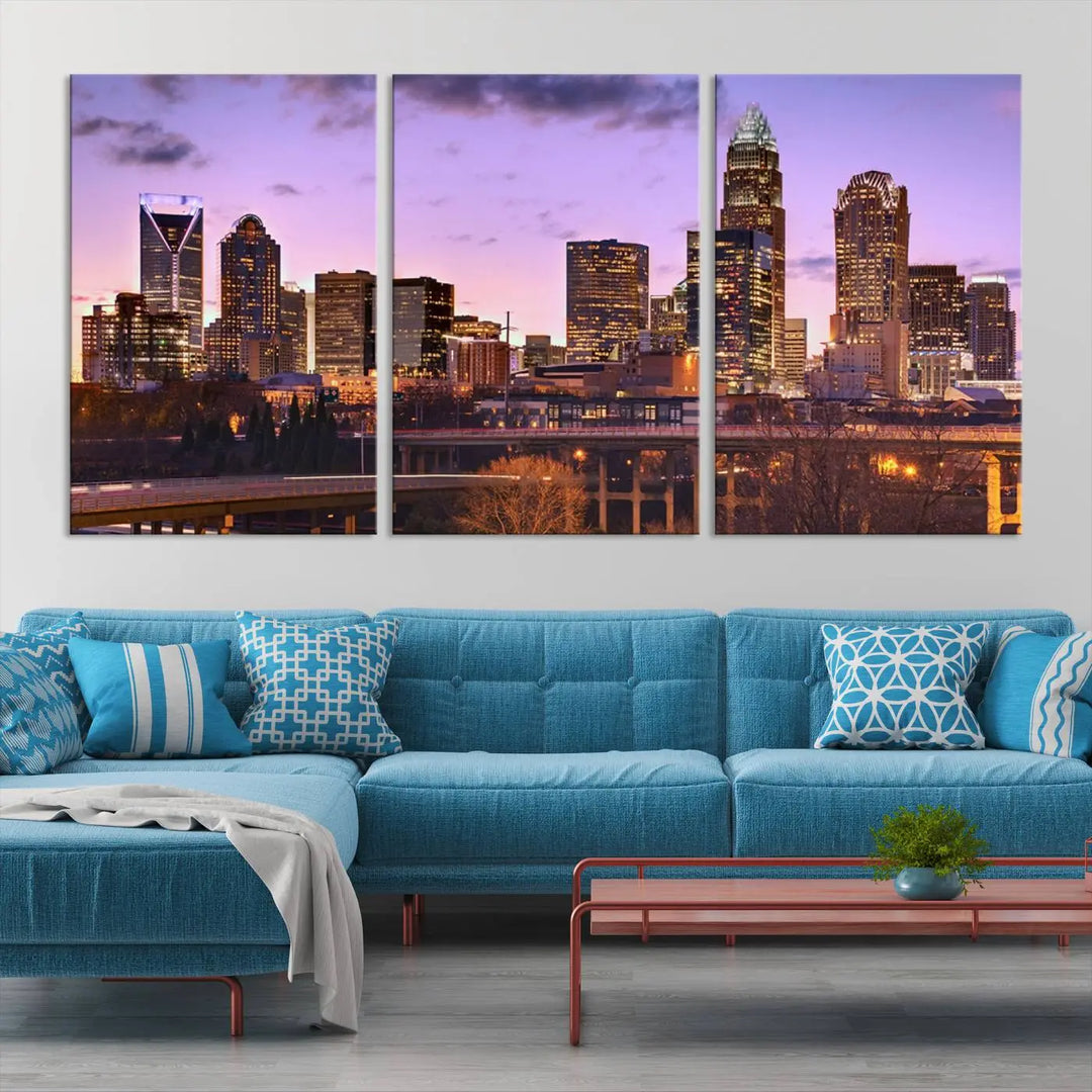 The "Charlotte City Lights Sunset Purple Skyline Cityscape View Wall Art Canvas Print" adorns the modern living room. This museum-quality piece is ready to hang and features a UV-protective coating to preserve its vibrant colors for years.