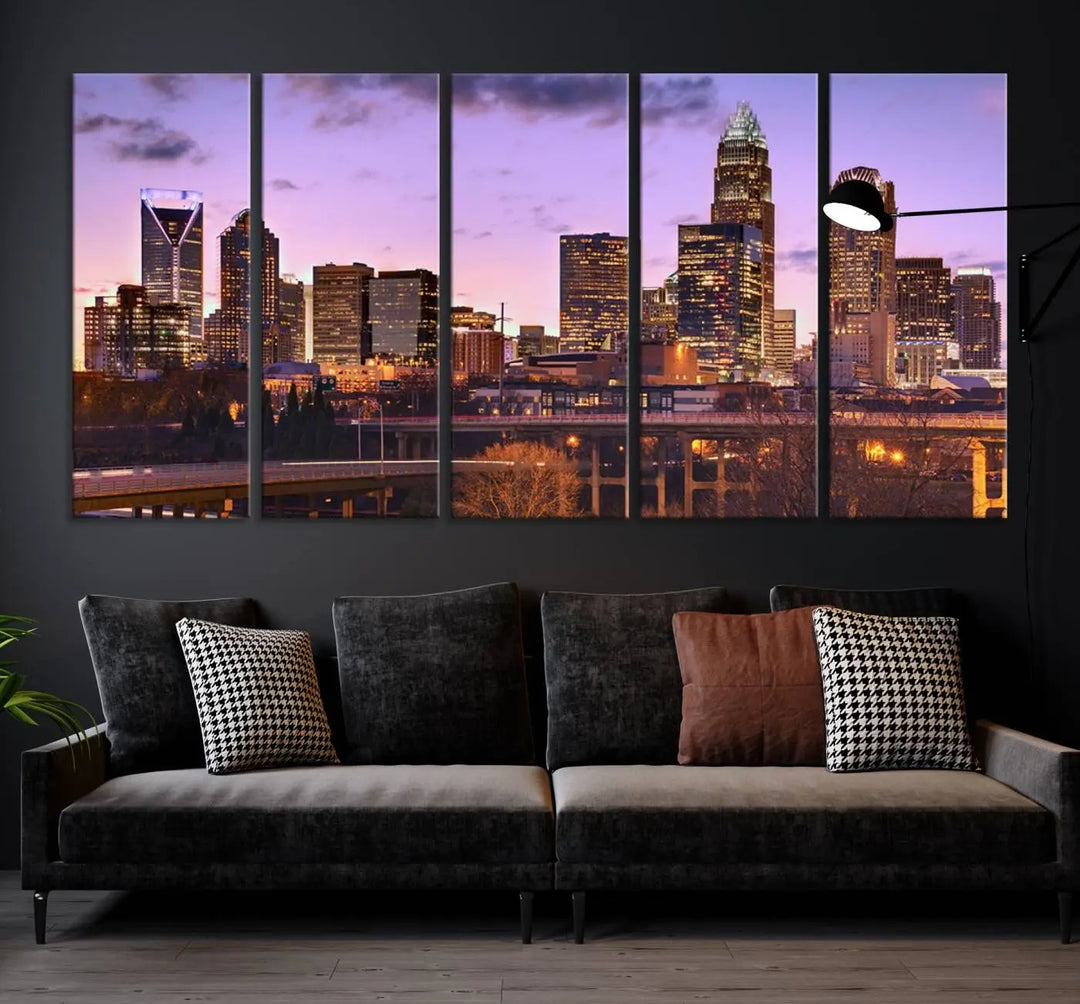 The "Charlotte City Lights Sunset Purple Skyline Cityscape View Wall Art Canvas Print" adorns the modern living room. This museum-quality piece is ready to hang and features a UV-protective coating to preserve its vibrant colors for years.