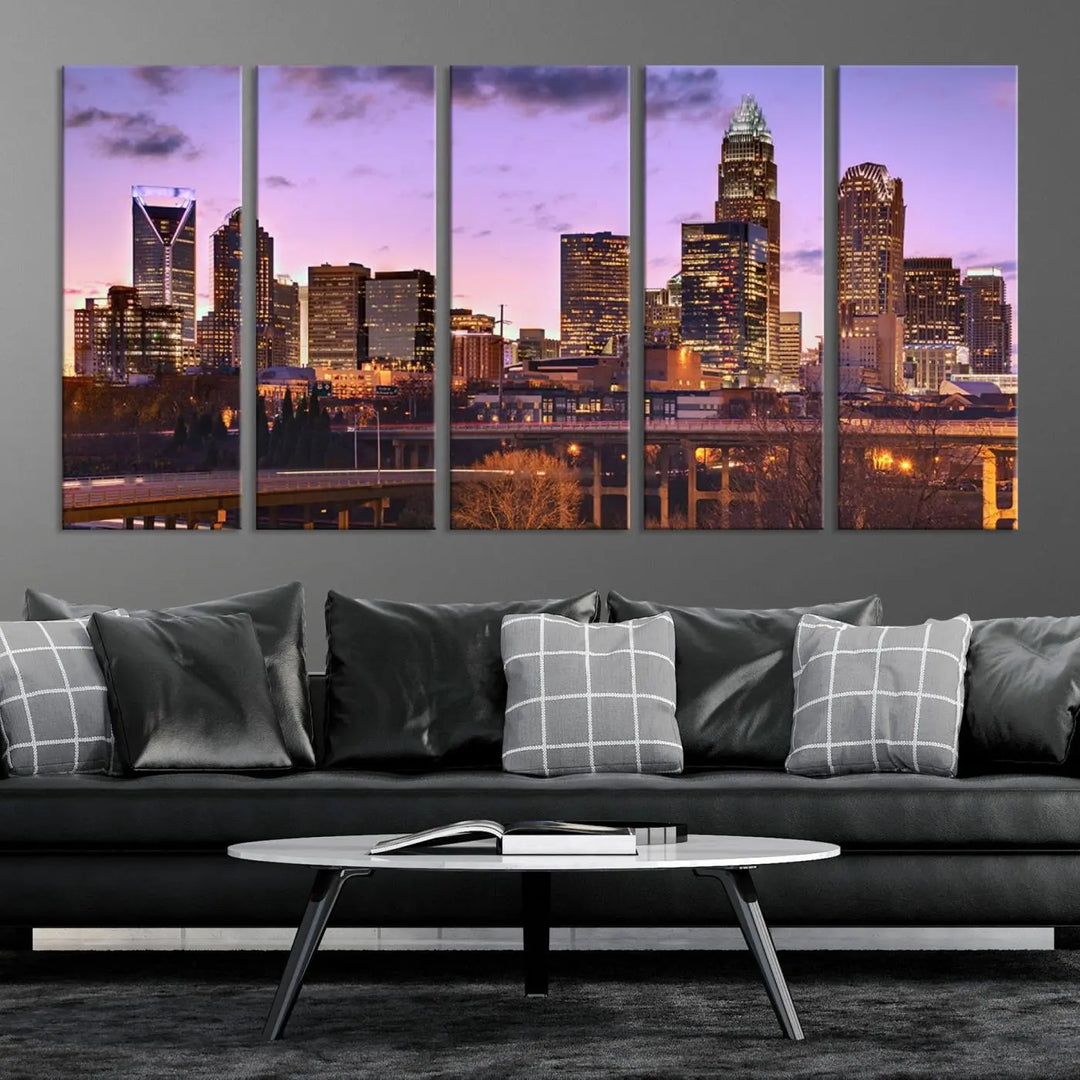 The "Charlotte City Lights Sunset Purple Skyline Cityscape View Wall Art Canvas Print" adorns the modern living room. This museum-quality piece is ready to hang and features a UV-protective coating to preserve its vibrant colors for years.