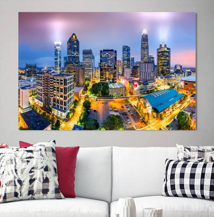 The living room features three large pieces of the *Charlotte City Lights Sunset Purple Skyline Cityscape View Wall Art Canvas Print*. Crafted on gallery-wrapped, museum-quality canvas with UV-protective coating, they grace the wall and add an artistic flair to the space.