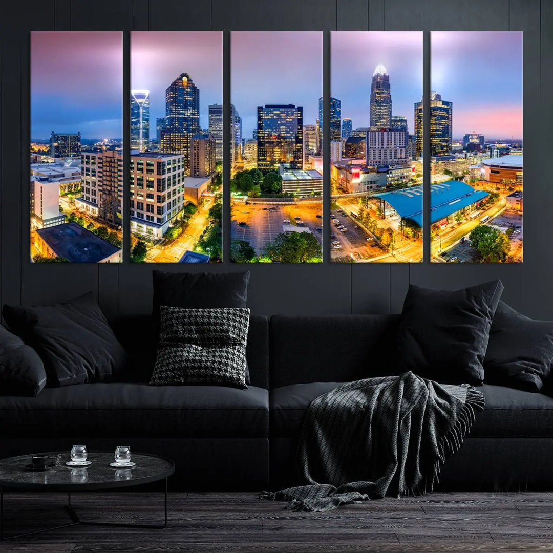 The living room features three large pieces of the *Charlotte City Lights Sunset Purple Skyline Cityscape View Wall Art Canvas Print*. Crafted on gallery-wrapped, museum-quality canvas with UV-protective coating, they grace the wall and add an artistic flair to the space.