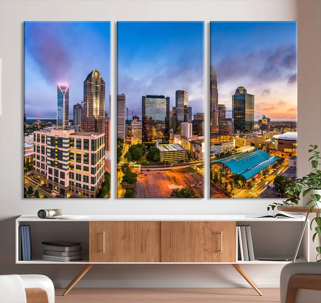 In the living room, a museum-quality, gallery-wrapped canvas titled "Charlotte City Lights Sunset Purple and Blue Skyline" showcases a stunning multi-panel cityscape. The artwork's UV-protective coating guarantees its brilliance for years to come.