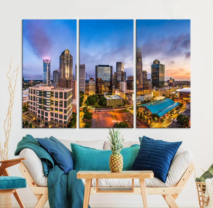 In the living room, a museum-quality, gallery-wrapped canvas titled "Charlotte City Lights Sunset Purple and Blue Skyline" showcases a stunning multi-panel cityscape. The artwork's UV-protective coating guarantees its brilliance for years to come.