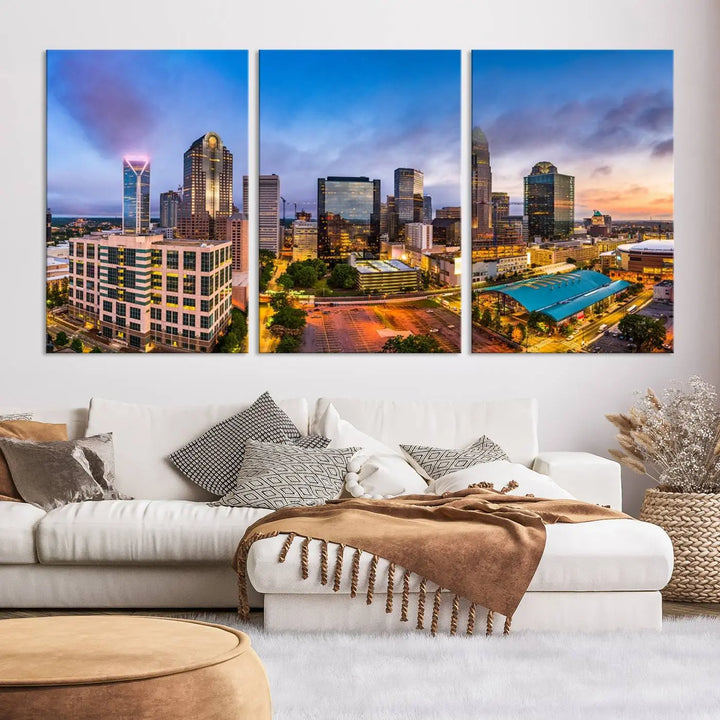 In the living room, a museum-quality, gallery-wrapped canvas titled "Charlotte City Lights Sunset Purple and Blue Skyline" showcases a stunning multi-panel cityscape. The artwork's UV-protective coating guarantees its brilliance for years to come.