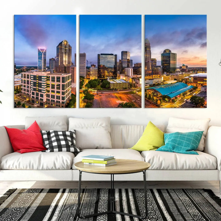 In the living room, a museum-quality, gallery-wrapped canvas titled "Charlotte City Lights Sunset Purple and Blue Skyline" showcases a stunning multi-panel cityscape. The artwork's UV-protective coating guarantees its brilliance for years to come.