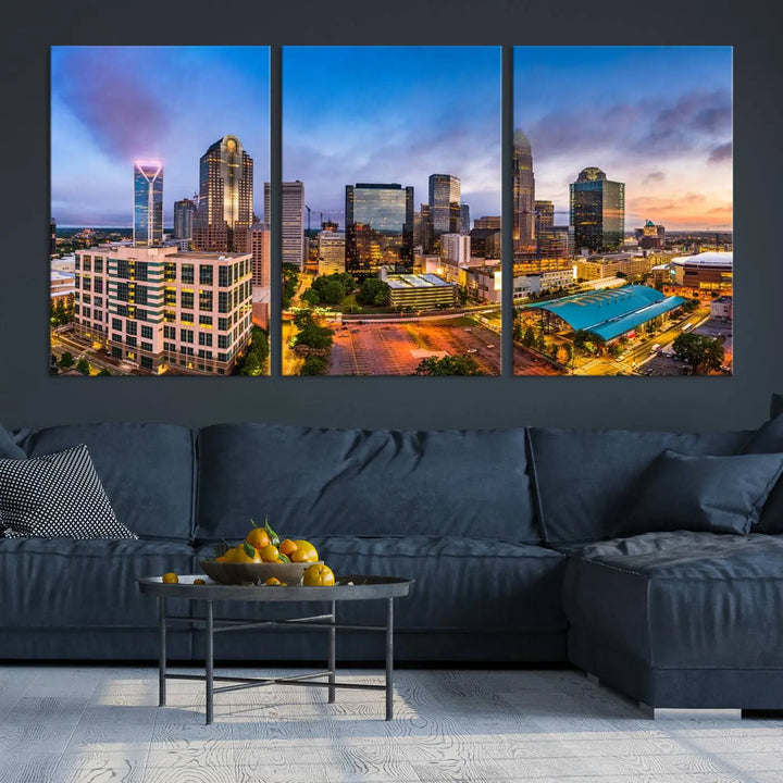 In the living room, a museum-quality, gallery-wrapped canvas titled "Charlotte City Lights Sunset Purple and Blue Skyline" showcases a stunning multi-panel cityscape. The artwork's UV-protective coating guarantees its brilliance for years to come.