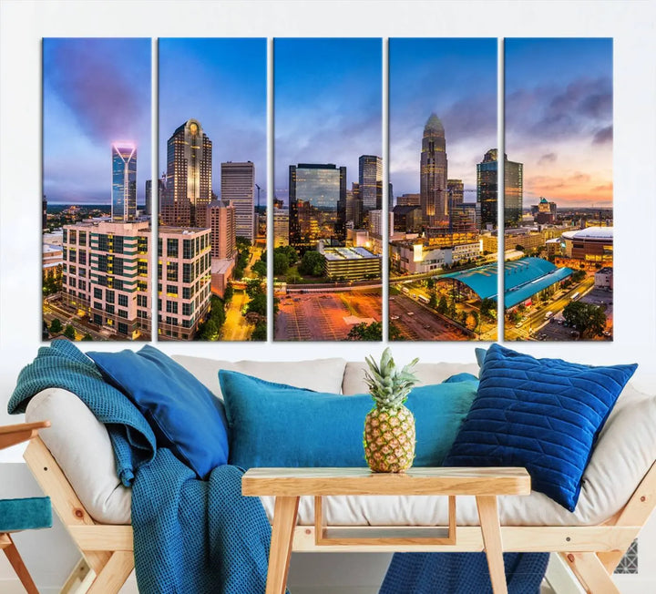 In the living room, a museum-quality, gallery-wrapped canvas titled "Charlotte City Lights Sunset Purple and Blue Skyline" showcases a stunning multi-panel cityscape. The artwork's UV-protective coating guarantees its brilliance for years to come.