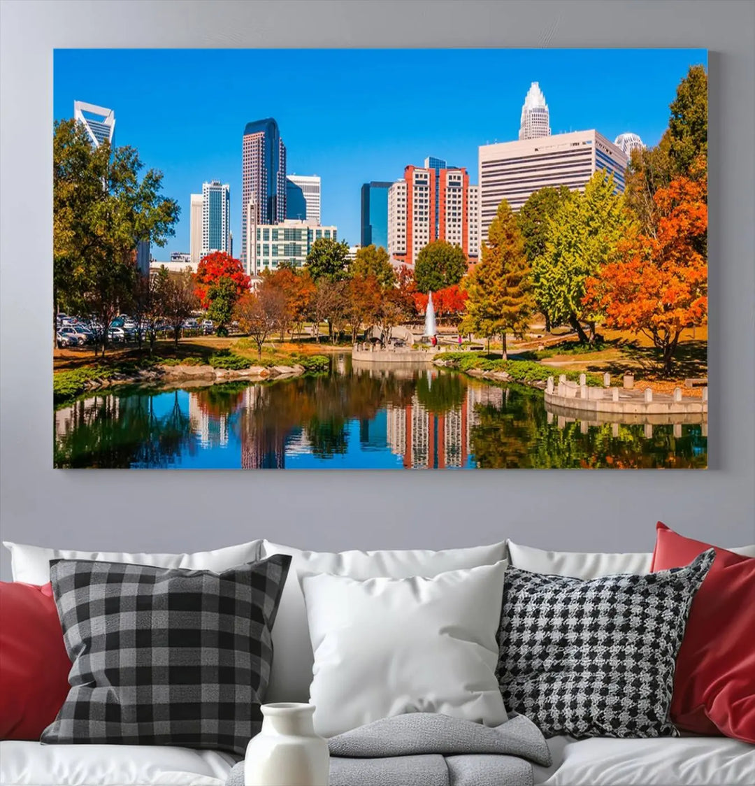 The Charlotte City Park at Fall Skyline Cityscape View wall art canvas print features a city panorama with a park and lake accented by autumn trees. It is mounted on museum-quality canvas with UV-protective coating and decorates the space.