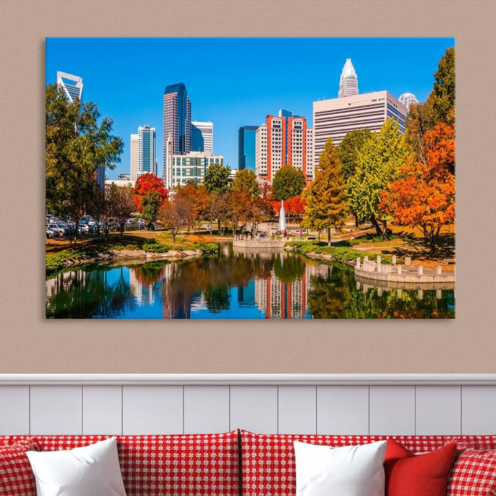 The Charlotte City Park at Fall Skyline Cityscape View wall art canvas print features a city panorama with a park and lake accented by autumn trees. It is mounted on museum-quality canvas with UV-protective coating and decorates the space.