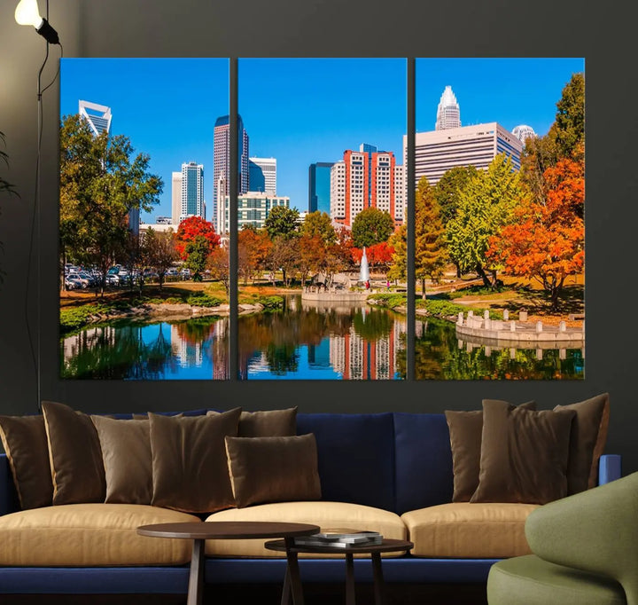 The Charlotte City Park at Fall Skyline Cityscape View wall art canvas print features a city panorama with a park and lake accented by autumn trees. It is mounted on museum-quality canvas with UV-protective coating and decorates the space.