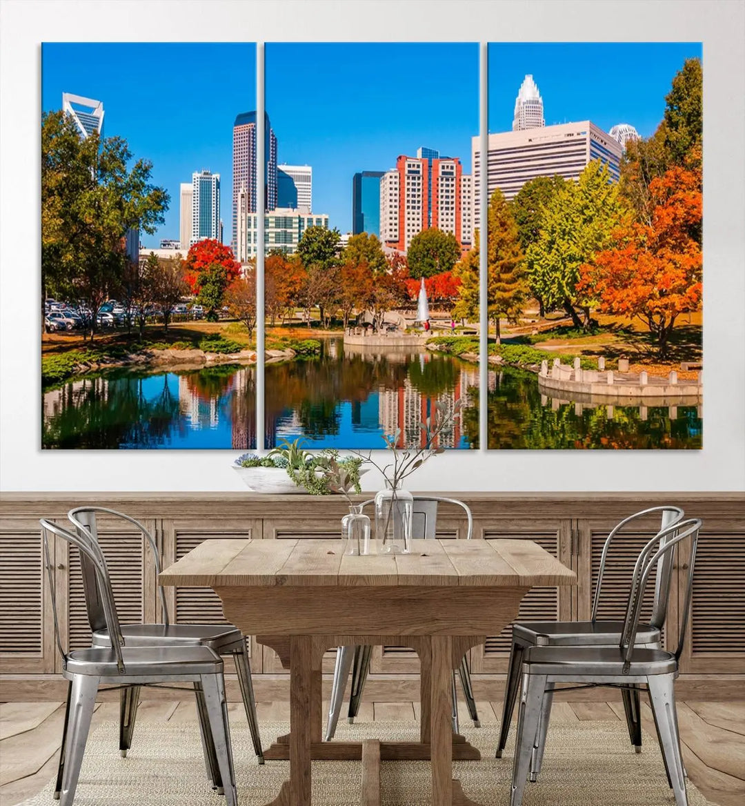 The Charlotte City Park at Fall Skyline Cityscape View wall art canvas print features a city panorama with a park and lake accented by autumn trees. It is mounted on museum-quality canvas with UV-protective coating and decorates the space.