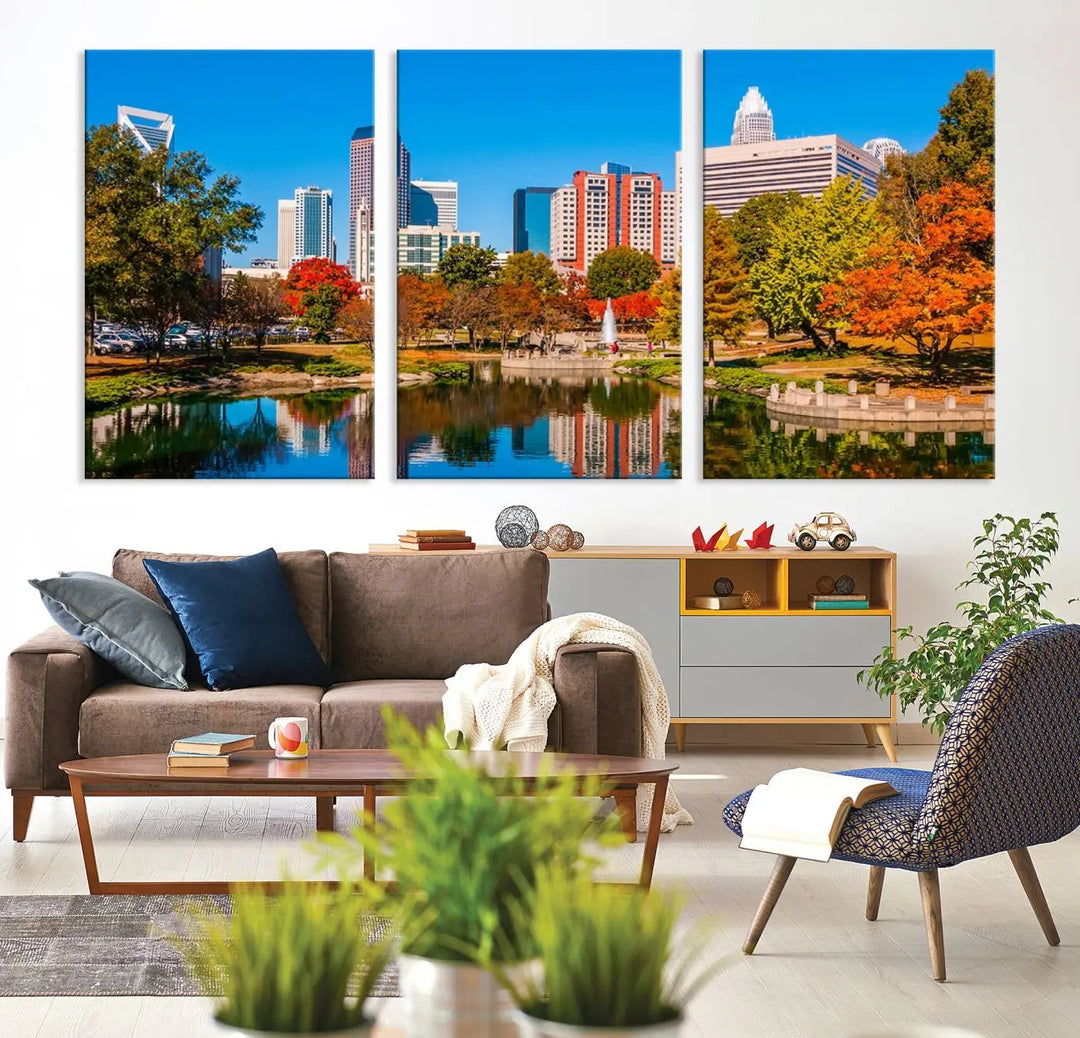 The Charlotte City Park at Fall Skyline Cityscape View wall art canvas print features a city panorama with a park and lake accented by autumn trees. It is mounted on museum-quality canvas with UV-protective coating and decorates the space.