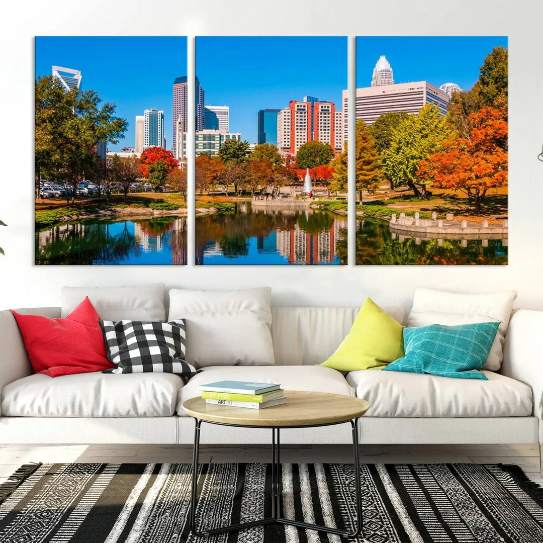 The Charlotte City Park at Fall Skyline Cityscape View wall art canvas print features a city panorama with a park and lake accented by autumn trees. It is mounted on museum-quality canvas with UV-protective coating and decorates the space.