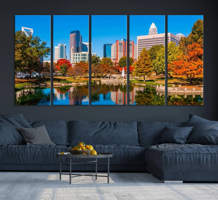 The Charlotte City Park at Fall Skyline Cityscape View wall art canvas print features a city panorama with a park and lake accented by autumn trees. It is mounted on museum-quality canvas with UV-protective coating and decorates the space.