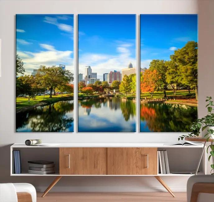 The Charlotte City Park at Spring Skyline Cityscape View Wall Art Canvas Print features a triptych of a city park scene with a calm lake, colorful autumn trees, and skyline. Crafted on museum-quality canvas and hand-assembled with a frame, this artwork is ready to hang and ideal for bringing elegance and serenity to your living space.