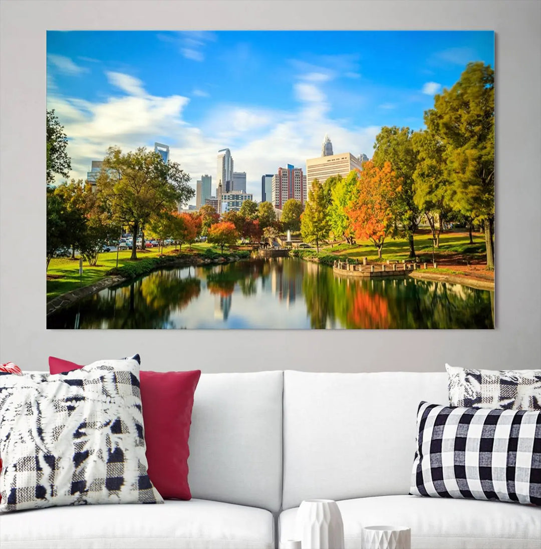 The Charlotte City Park at Spring Skyline Cityscape View wall art canvas print is a triptych featuring a scenic park with a lake and city skyline. It is gallery-wrapped on museum-quality canvases.