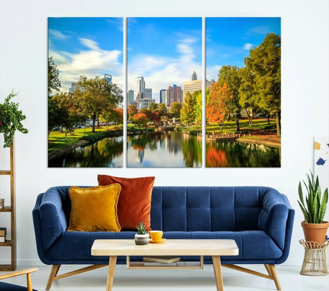 The Charlotte City Park at Spring Skyline Cityscape View wall art canvas print is a triptych featuring a scenic park with a lake and city skyline. It is gallery-wrapped on museum-quality canvases.