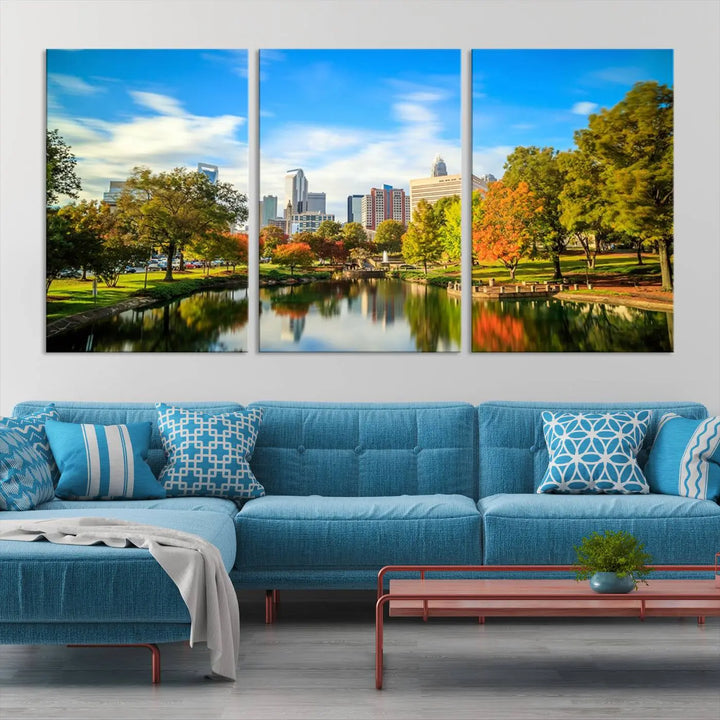 The Charlotte City Park at Spring Skyline Cityscape View wall art canvas print is a triptych featuring a scenic park with a lake and city skyline. It is gallery-wrapped on museum-quality canvases.