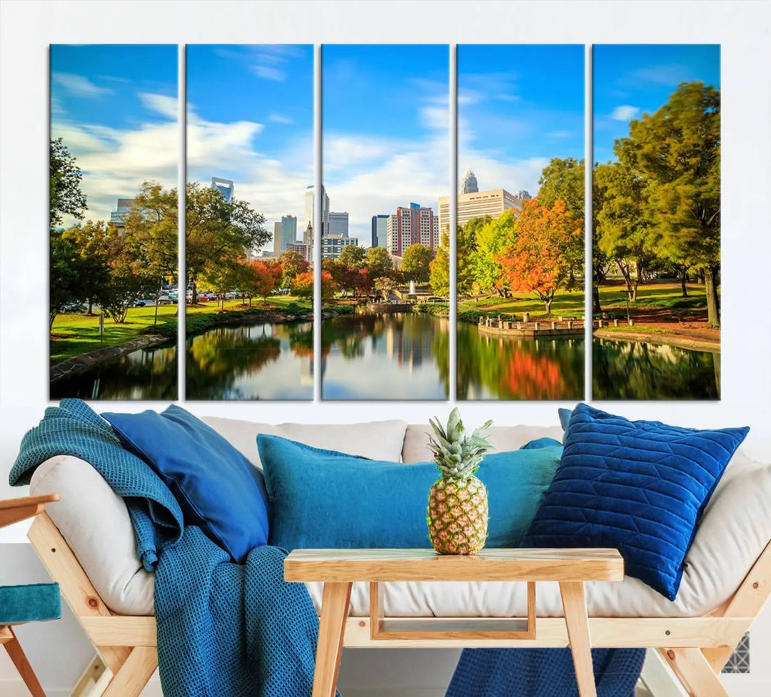 The Charlotte City Park at Spring Skyline Cityscape View wall art canvas print is a triptych featuring a scenic park with a lake and city skyline. It is gallery-wrapped on museum-quality canvases.