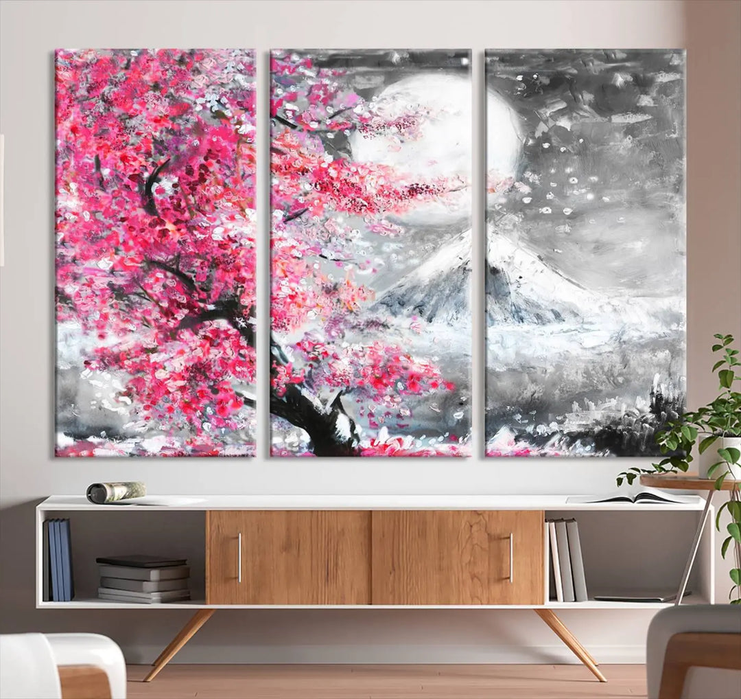 The living room features a striking gallery-wrapped canvas with UV-protective coating, showcasing the "Cherry Blossom Painting Canvas Wall Art Full Moon Art Winter Canvas Art," which depicts a cherry blossom tree with a mountain backdrop.