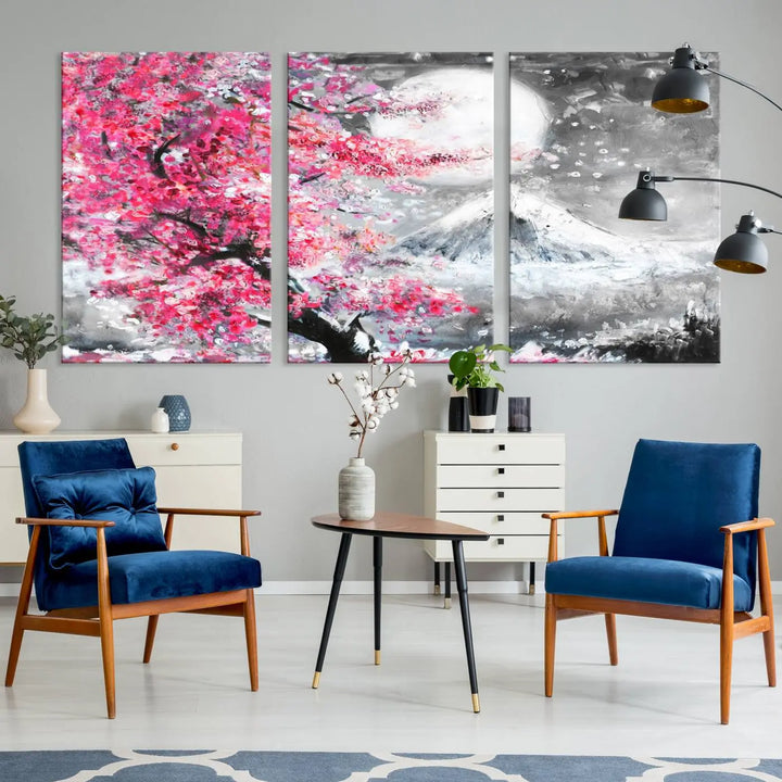 The living room features a striking gallery-wrapped canvas with UV-protective coating, showcasing the "Cherry Blossom Painting Canvas Wall Art Full Moon Art Winter Canvas Art," which depicts a cherry blossom tree with a mountain backdrop.