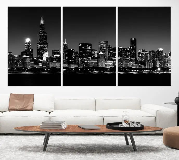 Elegantly displayed above the modern living room, a black and white cityscape stretches across three panels. This premium Chicago Wall Art Canvas Print captures the city's skyline at night, crafted with museum-quality canvas and enhanced by a UV-protective coating to maintain its vibrant appearance. It arrives ready to hang for seamless installation.