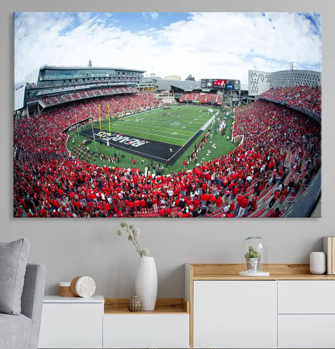 The Cincinnati Bearcats Football Team Print - Nippert Stadium Wall Art Canvas Print showcases a panoramic photo of a packed football stadium with a green field. This high-resolution canvas print provides museum-quality detail, capturing the vibrant energy and atmosphere for everyone to admire.