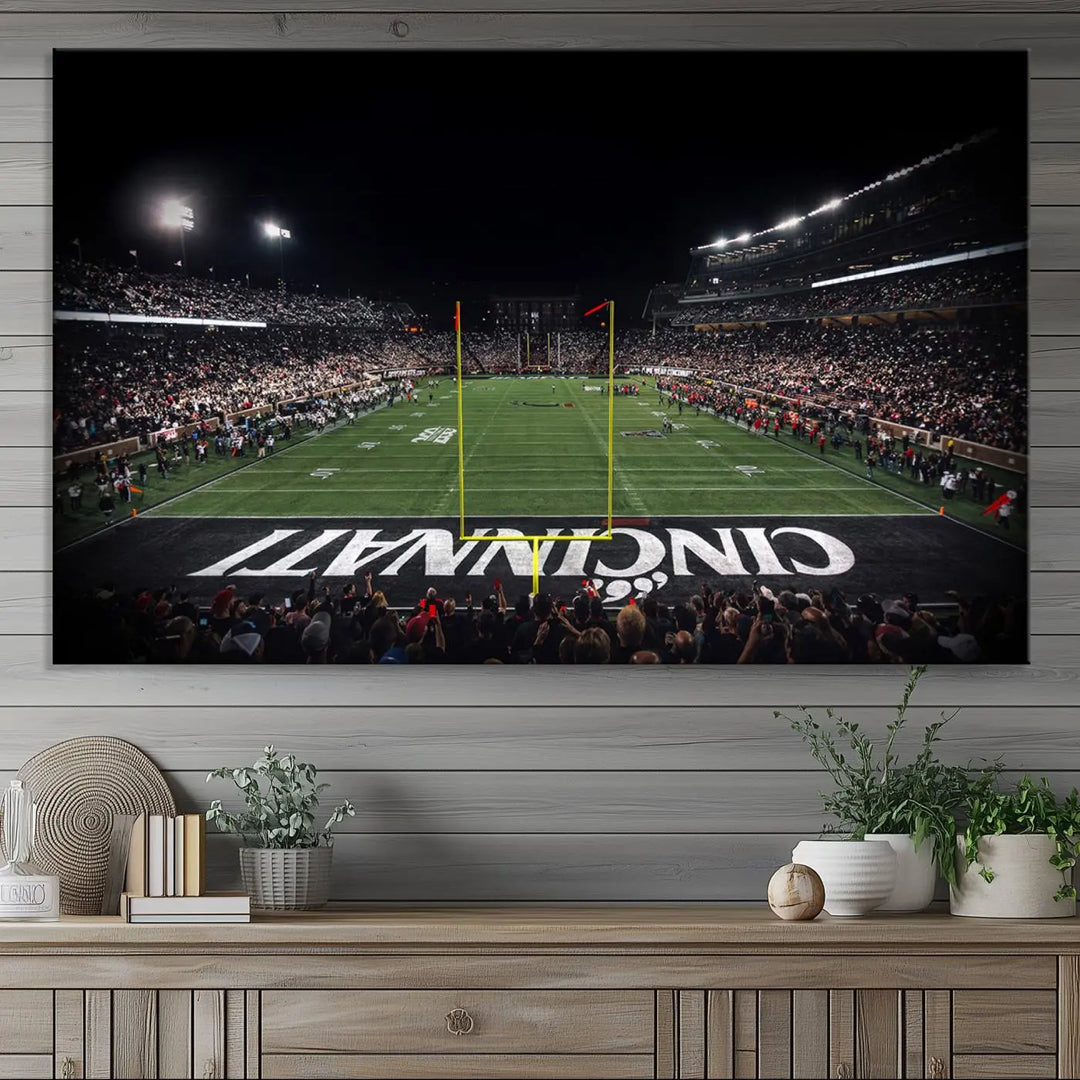 The Cincinnati Bearcats Football Team Print - Nippert Stadium Wall Art Canvas captures a panoramic view of the football stadium at night, offering museum-quality presentation. The vibrant colors and high-resolution printing bring every detail to life.