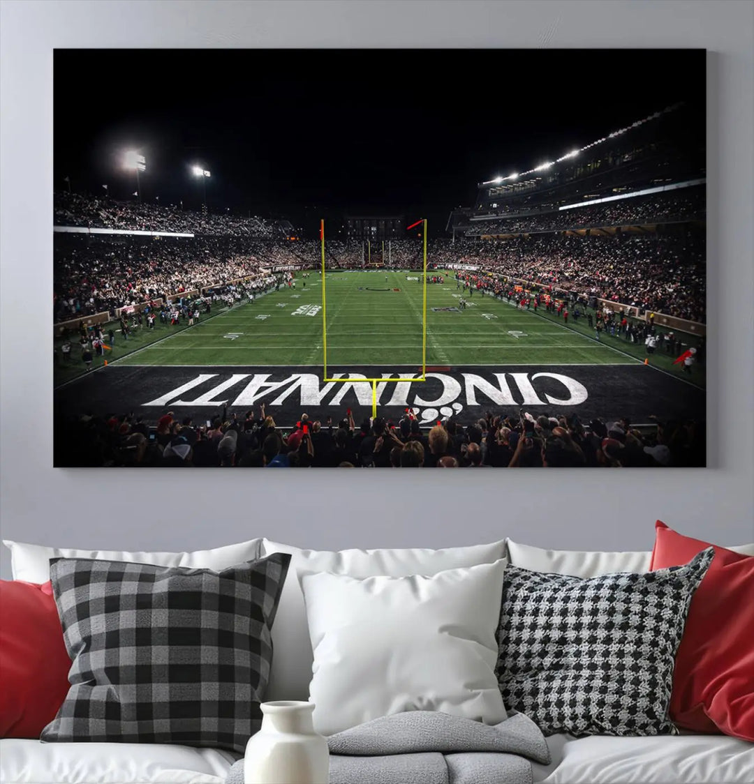 The Cincinnati Bearcats Football Team Print - Nippert Stadium Wall Art Canvas captures a panoramic view of the football stadium at night, offering museum-quality presentation. The vibrant colors and high-resolution printing bring every detail to life.