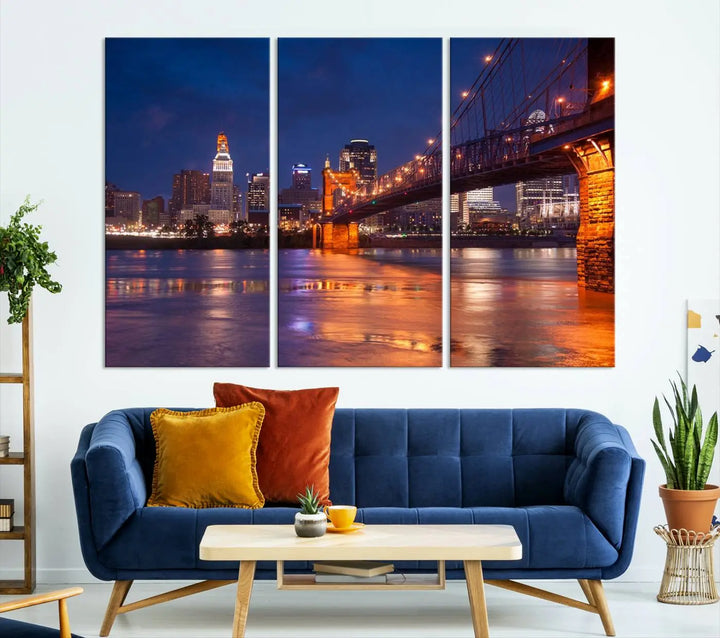 The Cincinnati City Bridge Lights Night Skyline Cityscape View Wall Art Canvas Print is a magnificent triptych crafted on museum-quality polycotton canvas. It features a beautifully illuminated bridge over water at night, enhancing any living room with its elegant design.