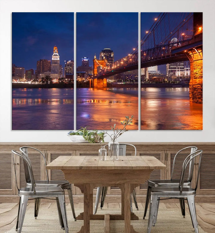 The Cincinnati City Bridge Lights Night Skyline Cityscape View Wall Art Canvas Print is a magnificent triptych crafted on museum-quality polycotton canvas. It features a beautifully illuminated bridge over water at night, enhancing any living room with its elegant design.