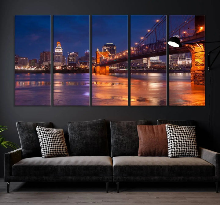 The Cincinnati City Bridge Lights Night Skyline Cityscape View Wall Art Canvas Print is a magnificent triptych crafted on museum-quality polycotton canvas. It features a beautifully illuminated bridge over water at night, enhancing any living room with its elegant design.