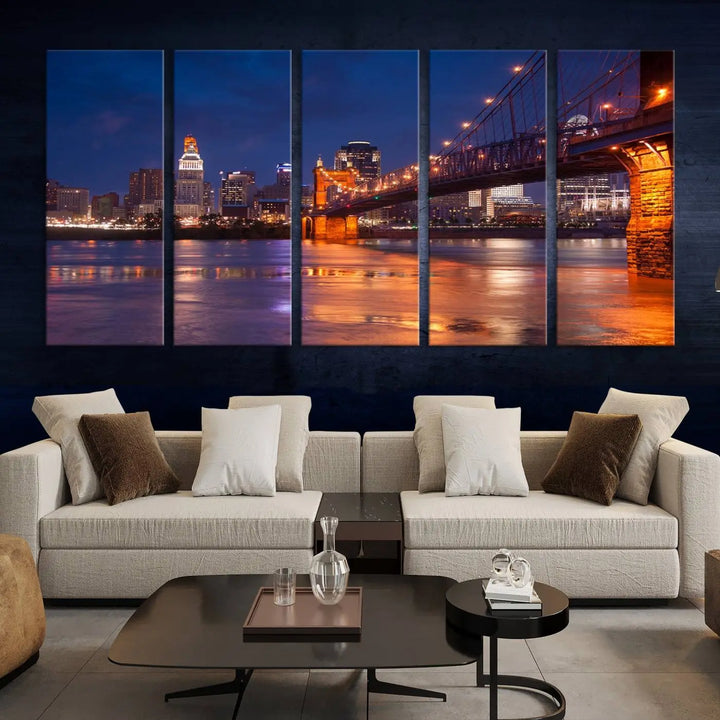 The Cincinnati City Bridge Lights Night Skyline Cityscape View Wall Art Canvas Print is a magnificent triptych crafted on museum-quality polycotton canvas. It features a beautifully illuminated bridge over water at night, enhancing any living room with its elegant design.