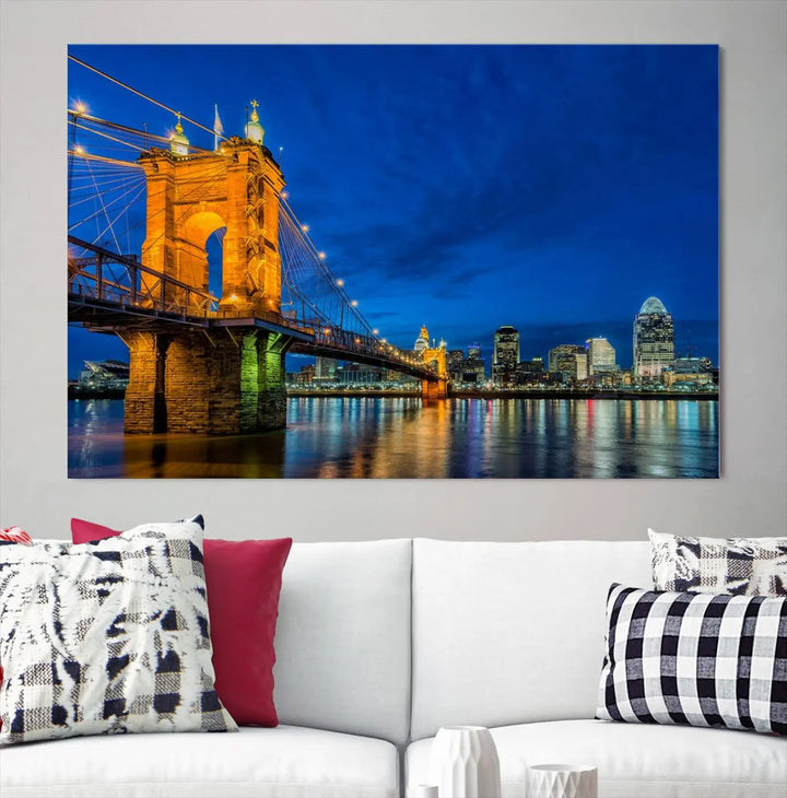 The living room features a museum-quality, multi-panel wall art titled "Cincinnati City Bridge Lights Night Skyline Cityscape View Wall Art Canvas Print," which depicts a lit-up bridge at night. The gallery-wrapped canvas adds a touch of elegance to the space.