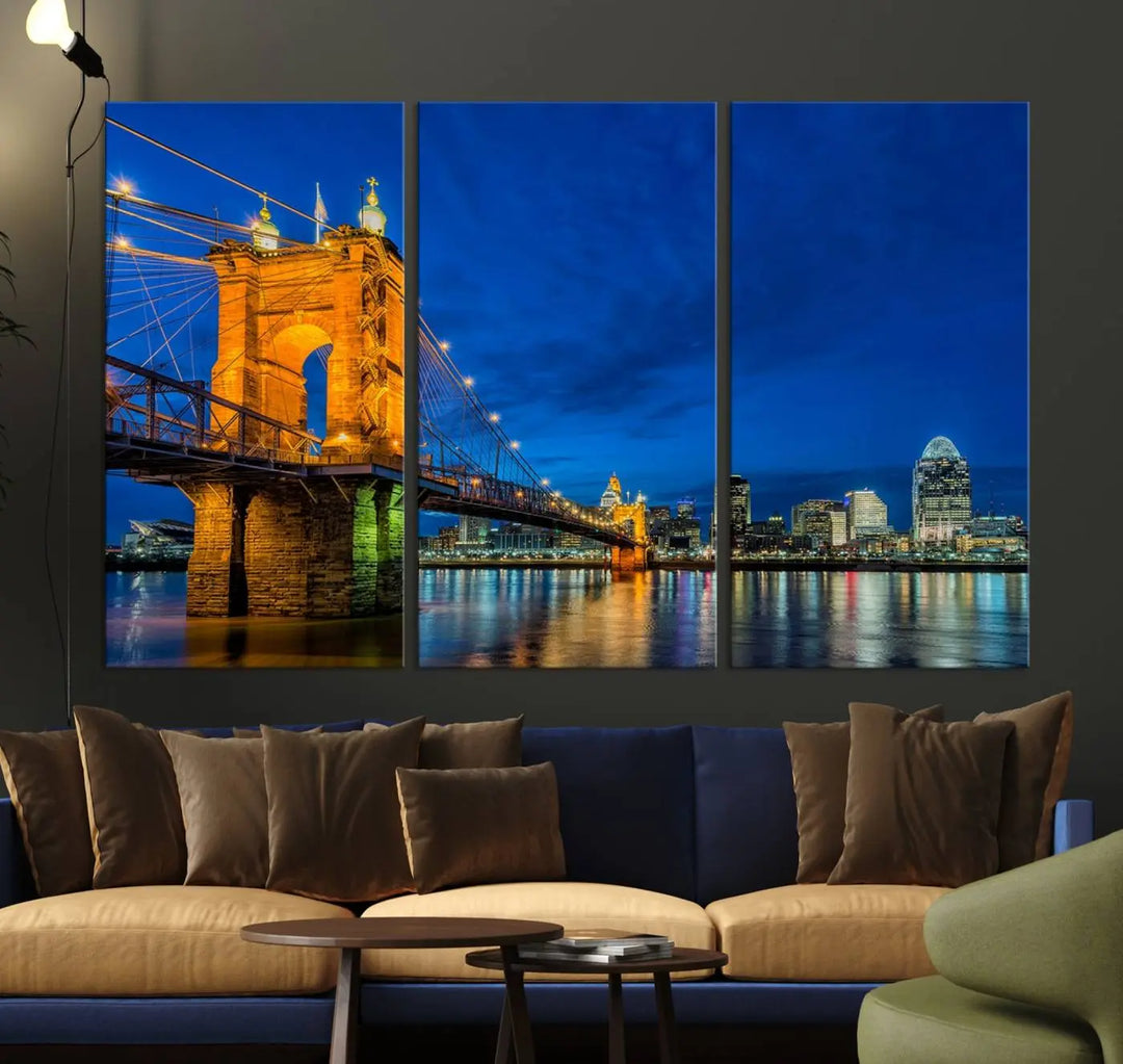 The living room features a museum-quality, multi-panel wall art titled "Cincinnati City Bridge Lights Night Skyline Cityscape View Wall Art Canvas Print," which depicts a lit-up bridge at night. The gallery-wrapped canvas adds a touch of elegance to the space.